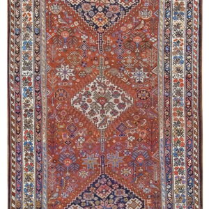 Ornate red and navy tribal runner rug featuring three large stepped geometric medallions and detailed borders.