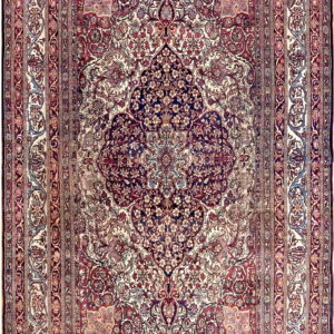 Intricate traditional rug featuring a large navy medallion on a cream and burgundy floral field.