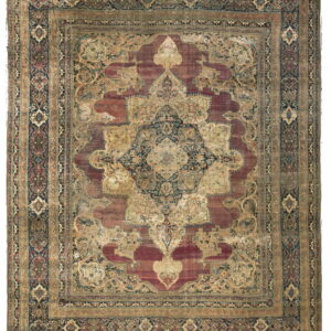 Traditional rug featuring a large navy and gold medallion on a faded maroon field with ornate borders.