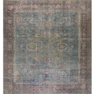Distressed traditional rug featuring a teal field, complex borders, and floral patterns in rust and beige.