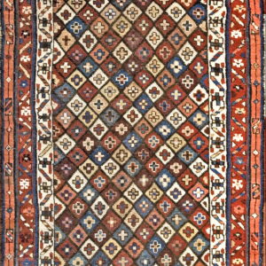 Geometric runner rug featuring multicolored diamonds with small cross motifs and wide terracotta and blue borders.