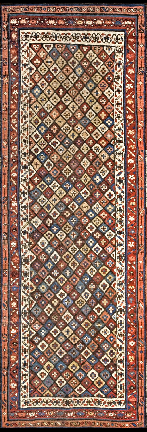 Geometric runner rug featuring multicolored diamonds with small cross motifs and wide terracotta and blue borders.