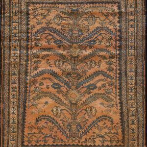 Terracotta rug featuring a stylized blue and gold medallion design and elaborate geometric borders.