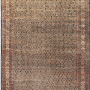 Muted traditional rug with an all-over repeating dark blue and beige geometric pattern and detailed borders.