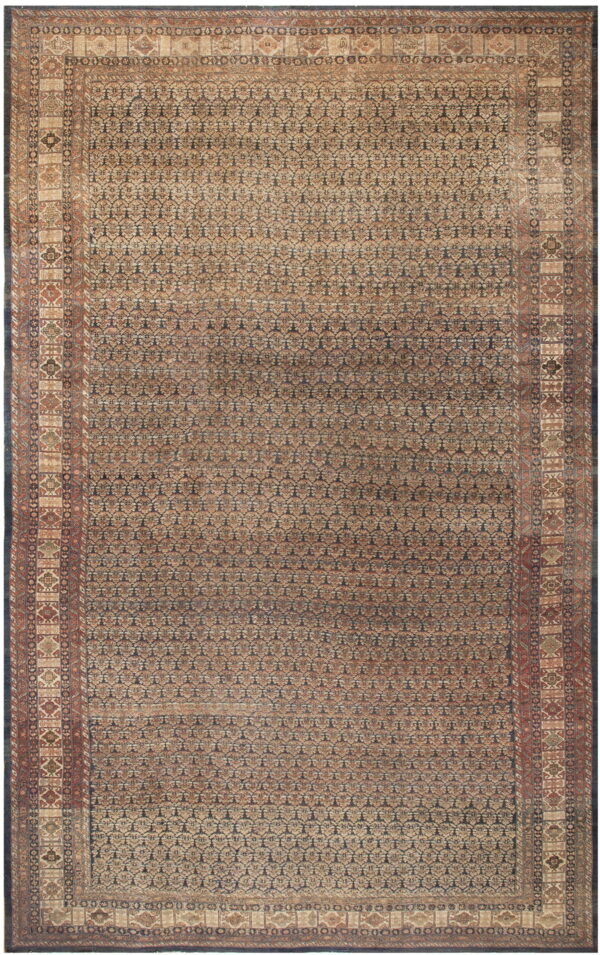 Muted traditional rug with an all-over repeating dark blue and beige geometric pattern and detailed borders.