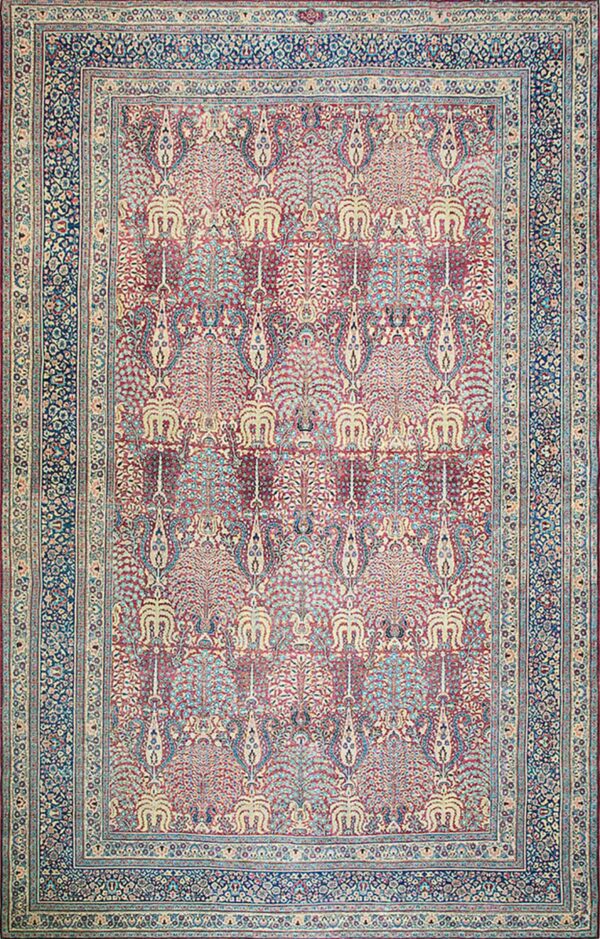 Red and cream rug with repeating stylized tree patterns and a dark blue floral border.