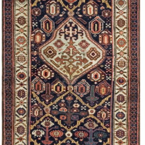 Dark blue runner rug featuring a central ivory medallion and geometric tribal patterns in rust, gold, and tan.