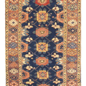 Navy blue runner featuring stylized red and gold geometric medallions and wide rust-toned borders.