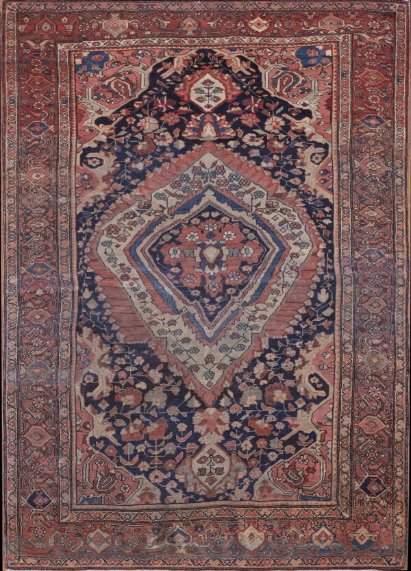 Navy and faded red traditional rug featuring a large central medallion and dense floral motifs.