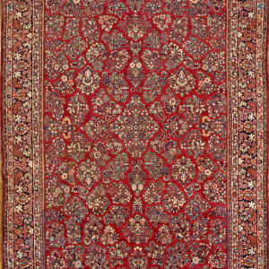 Rectangular rug with an intricate all-over floral pattern in red, navy, cream, and varied accents.