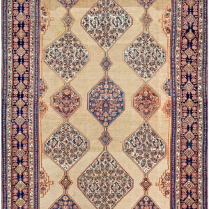 Tan rug with linked diamond medallions and ornate borders in deep blue, rust, and cream colors.