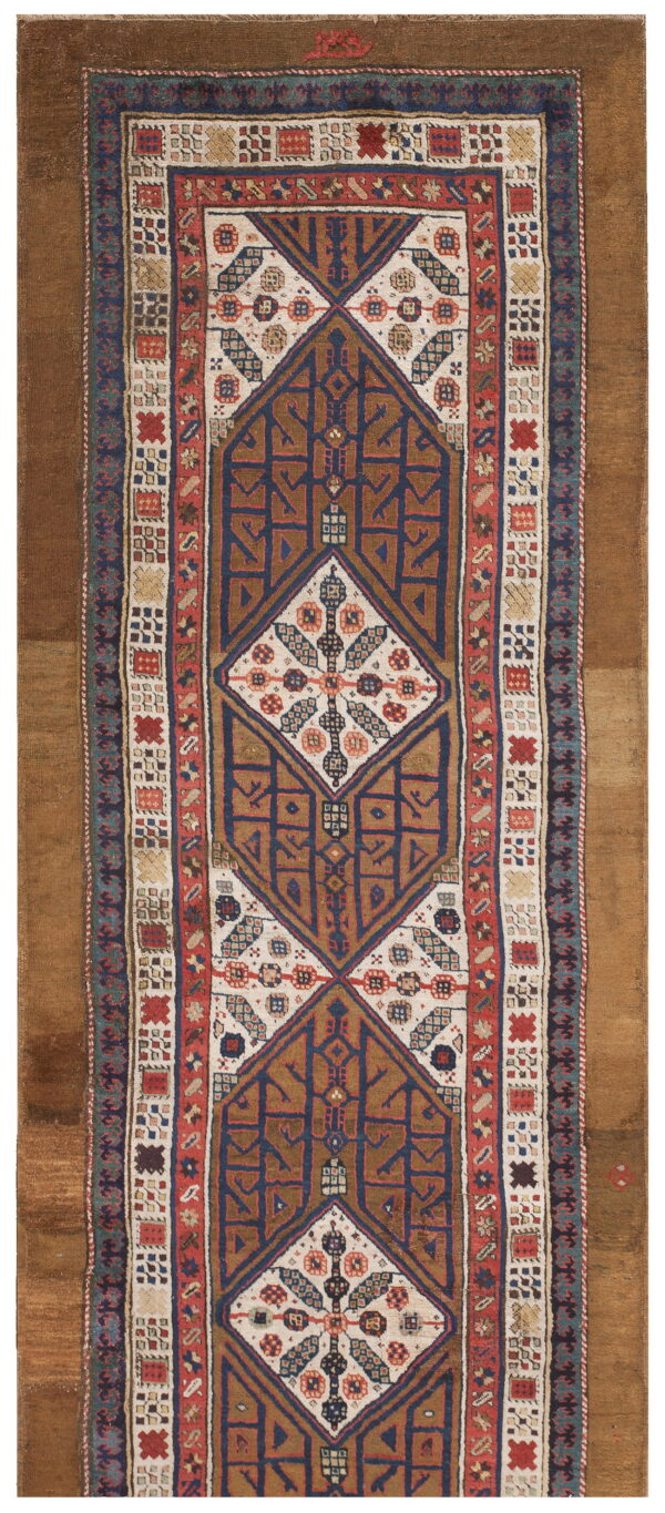 Geometric runner rug featuring stacked dark blue and brown diamond medallions on an off-white field.