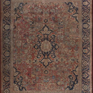 Low-pile ornamental rug in red and navy blue with a central medallion and detailed botanical motifs.