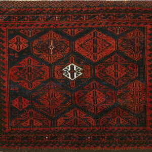 Square rug with dark red hexagonal patterns against a deep indigo field and geometric borders.