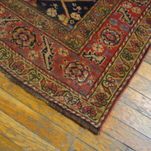 Colorful ornate rug on wooden floor