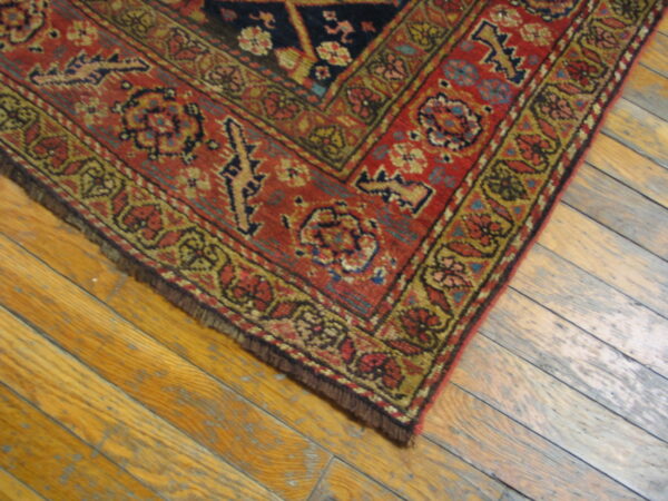 Colorful ornate rug on wooden floor
