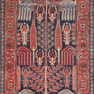 Geometric rug with a dark blue field, detailed red borders, and stylized tribal tree motifs.
