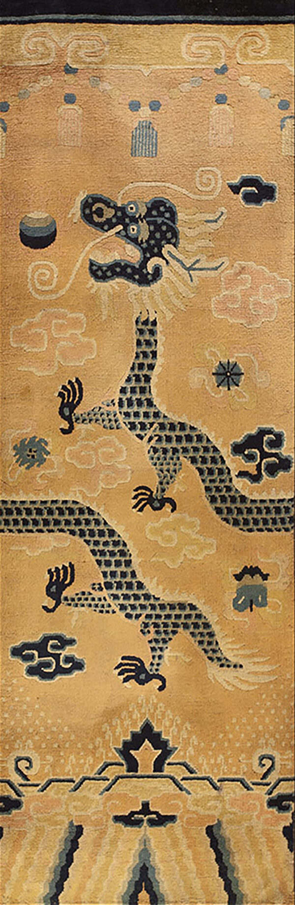 Detailed view of a gold rug with a segmented dark blue dragon and swirling pastel cloud motifs.