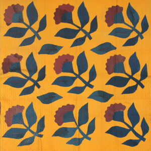 Repeating botanical pattern with deep blue and reddish-brown florals on a textured golden yellow background.