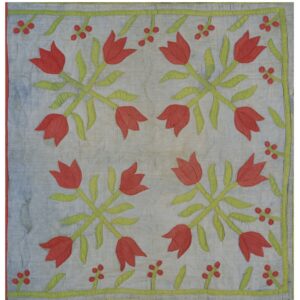 Pale blue appliquéd textile with large red tulip and green floral motifs in a symmetrical design.