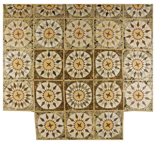 Muted patchwork rug featuring repeating circular starburst designs in beige, brown, and mustard yellow.
