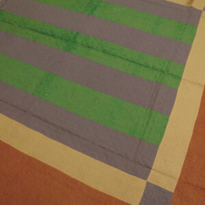 Quilted textile featuring wide horizontal stripes in green and grayish-purple, framed by yellow and rust borders.