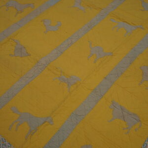 Wrinkled yellow and gray textile rug displaying diagonal stripes and silhouettes of various animals and a patterned border.