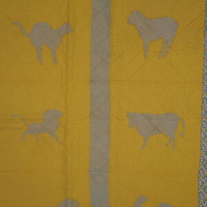 Yellow rug pattern featuring gray animal silhouettes, vertical gray columns, and a mint green patterned border.