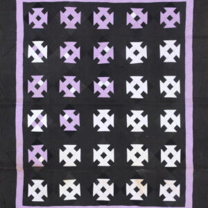 Black textile with rows of alternating white and lavender geometric crosses bordered by purple.