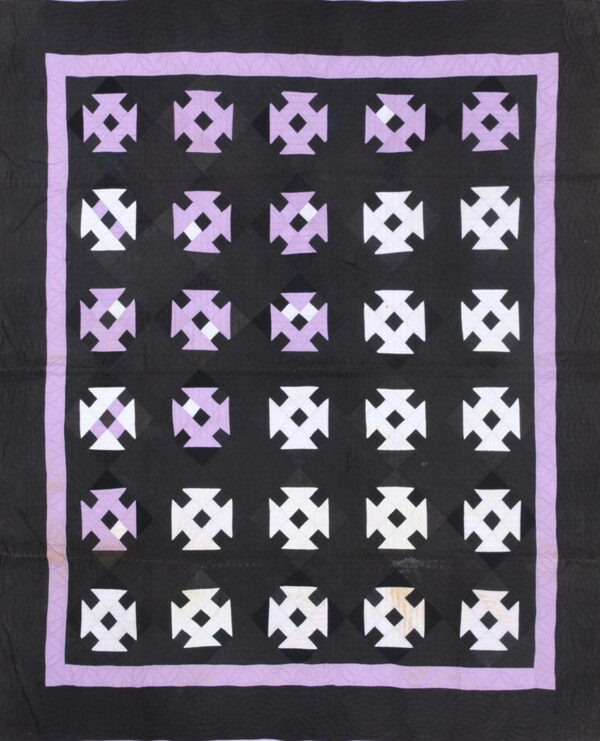Black textile with rows of alternating white and lavender geometric crosses bordered by purple.
