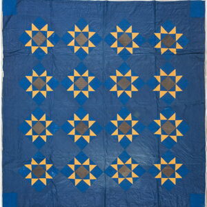 Navy blue textile featuring yellow and brown eight-pointed star designs set within a repeating diamond grid.