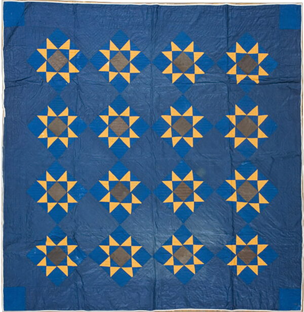 Navy blue textile featuring yellow and brown eight-pointed star designs set within a repeating diamond grid.
