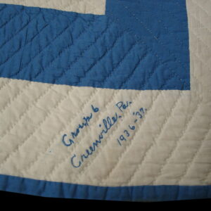 Cream and blue diamond quilted pattern featuring handwritten blue text on the cream section.