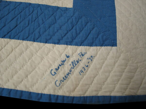 Cream and blue diamond quilted pattern featuring handwritten blue text on the cream section.