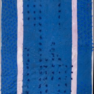 Blue low-pile rug with a pink inner border and varying blue textural knots rests on wood planks.