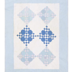 Flat woven textile in blues and white featuring four large geometric diamond patterns surrounded by a light blue border.