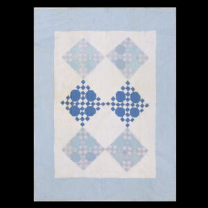 Patchwork textile featuring light blue, pink, and deep blue octagon and diamond repeating patterns on white.