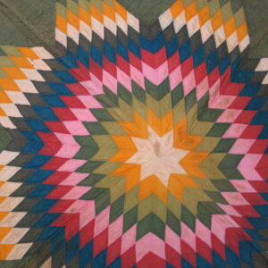 Vibrant starburst pattern featuring radiating diamonds in green, orange, pink, red, blue, and white patches.