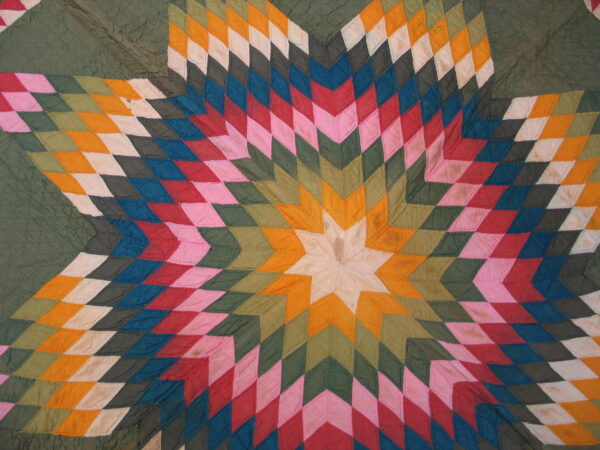 Vibrant starburst pattern featuring radiating diamonds in green, orange, pink, red, blue, and white patches.