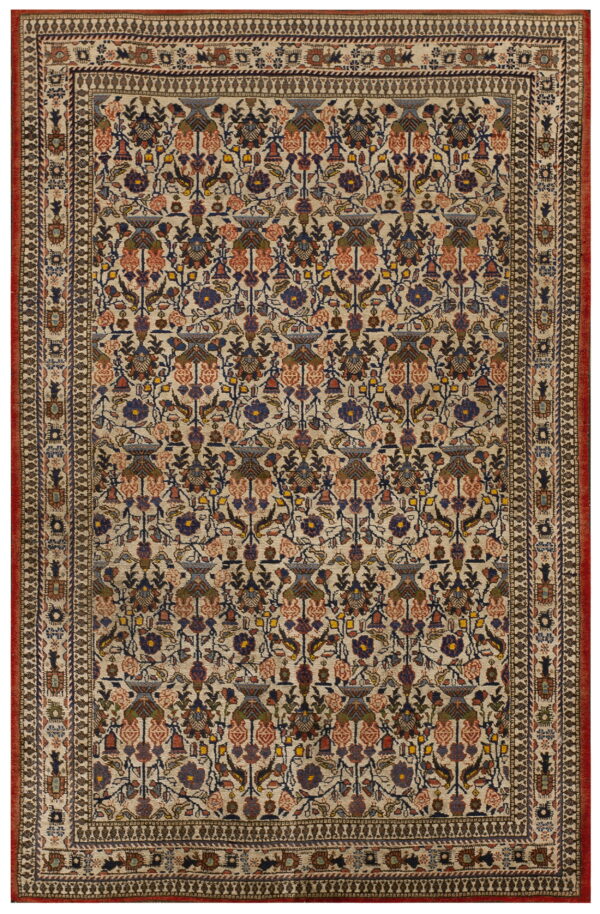 Antique qum iran knotted rug 1 Cream rug featuring a complex design of blue, rust, and green flowers with a multiple patterned border and red outer edge.