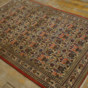Cream traditional rug featuring dense red, blue, and pink floral patterns on distressed yellow wood flooring.