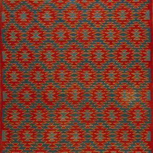 Red and teal rug with serrated geometric patterns, yellow outlining, and complex horizontal striped borders.