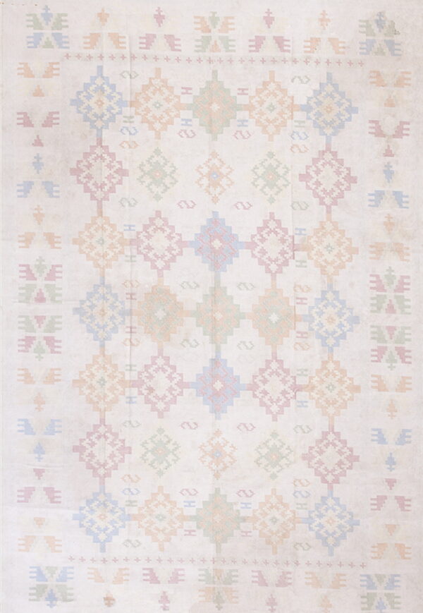 Cream-colored rug with pastel geometric diamond patterns in blue, pink, peach, and green.