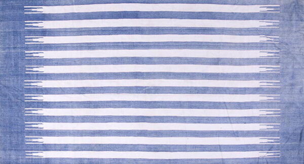 Low pile rug featuring blue and white horizontal stripes with geometric, stepped terminations.