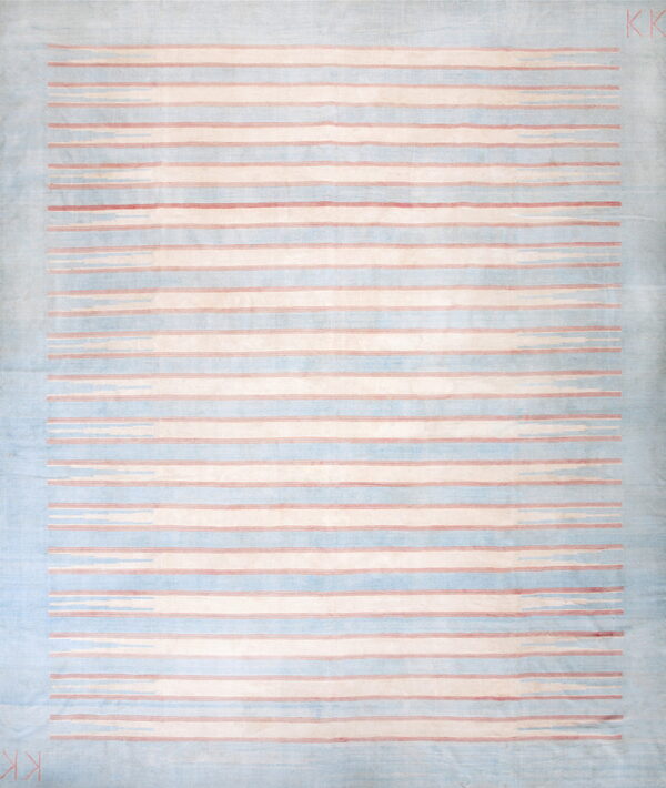Pale blue rug with cream, dusty rose, and blue horizontal stripes bordered by a wide solid blue edge.