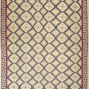 Low-pile runner rug with repeating beige, green, and dark blue geometric diamonds framed by a Greek key border.