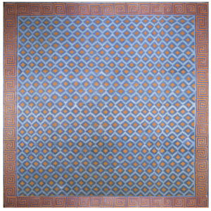 This medium blue rug has repeating orange geometric diamond motifs and a bold orange Greek key border.