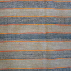 Close-up of a woven rug with wide horizontal stripes of indigo and tan, separated by narrow orange bands.