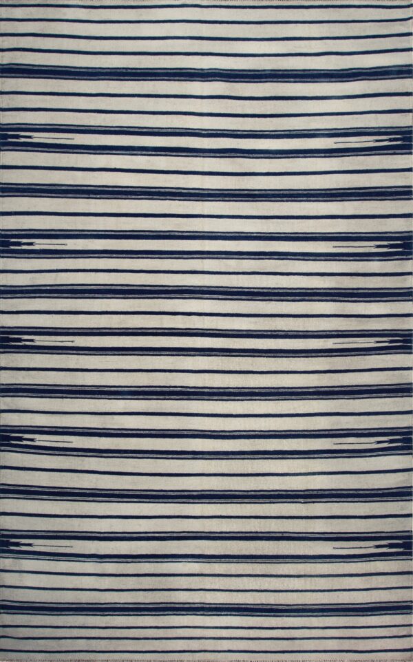 Striped flatweave rug in cream and deep blue displayed on rustic wooden floorboards.