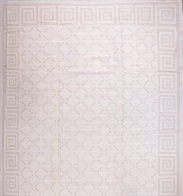 Light cream rug with a geometric greek key border and subtle tone-on-tone field pattern.